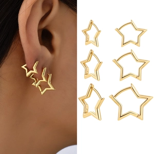 Three sizes of polished gold star hoop earrings for stacking on white background