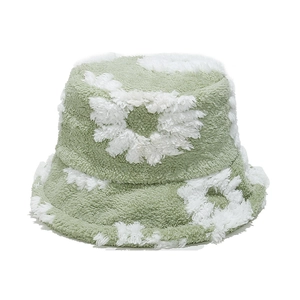 Detail of soft green teddy plush bucket hat featuring white sunflower daisy patterns