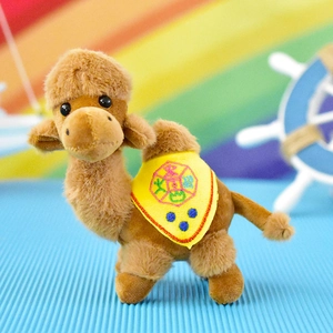 Detailed view of a cute brown plush camel pendant with a yellow embroidered saddle.