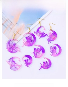 Detail showing DIY fairy moon resin earrings with glitter and purple gradient finish