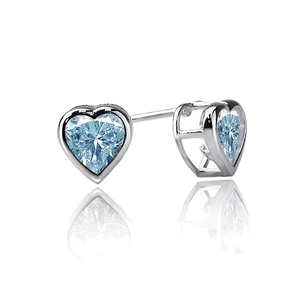 Close-up of heart-shaped light blue gemstone earrings with polished silver setting