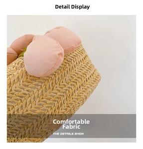 Close-up of hand-woven texture and pink fabric flower on a cute cartoon kids crossbody bag