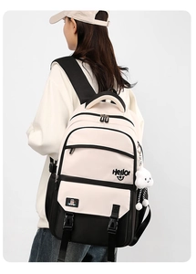 Rear view of minimalist cream and black school backpack with cute cloud pendant charm