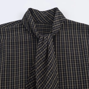 Classic black and grey plaid shirt featuring an adjustable tie neckline and woven texture