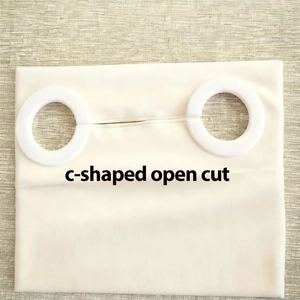 Detail of white velvet curtain fabric with functional c-shaped open cut rings for rod hanging