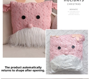 Pink knit Santa pillow with antlers showing plush rebound effect and vacuum packaging