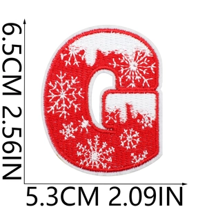 Macro view of red embroidered letter G patch with white snowflake and dimension markers