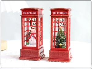 Detailed view of red retro telephone booth Christmas lanterns with snowman and tree inside