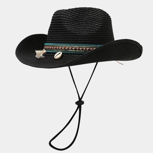 Close-up of black straw cowboy hat featuring ethnic woven band with shells and tassels