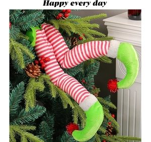 Close-up of plush Christmas elf legs tucked into tree branches for festive decor