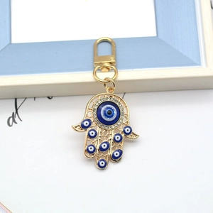 Hamsa Hand and Evil Eye keychain in gold finish with blue enamel and rhinestones