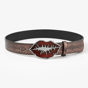 Vintage embossed leather belt with a red lip shaped metal buckle on a plain background