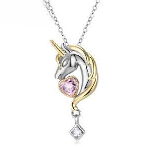 Macro shot of silver unicorn pendant featuring pink heart zircon and gold-tone horn detail