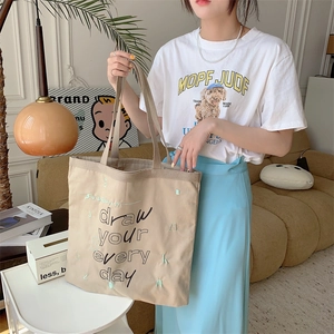 Minimalist beige canvas tote bag with black letter print for women daily commuting
