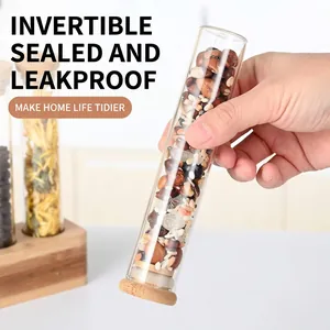 Leak-proof vertical glass storage tubes with bamboo lids for beans on a wooden stand