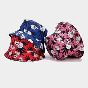 Detailed view of bucket hats featuring white skull and black leaf prints in various colors