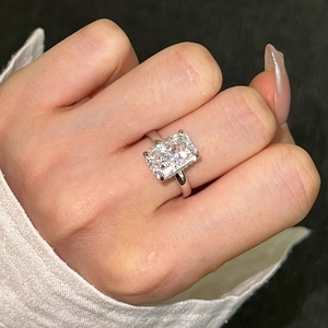 Macro detail of French style S925 silver ring with radiant ice cut rectangular zircon