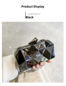 Detail of black acrylic geometric clutch with silver chain strap and angular top clasp