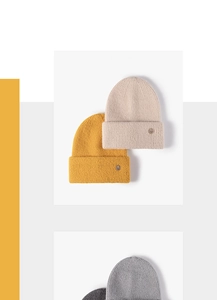 Close-up of ribbed knit texture on winter beanie with decorative metal V emblem