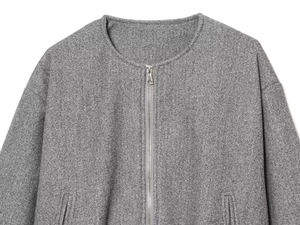 Close-up of a grey soft wool texture bomber jacket with metal zipper and round neck