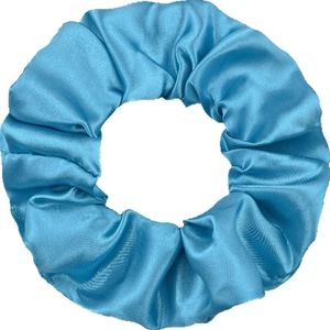 Elegant blue satin silk scrunchie with smooth glossy texture and pleated hair accessory design
