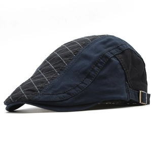 Detail of vintage navy blue and grey plaid cotton beret hat with adjustable metal buckle