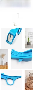 Macro detail of ergonomic blue ring fruit peeler featuring a sharp stainless steel blade