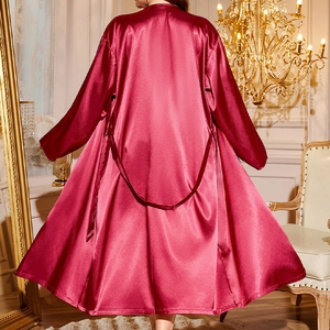 Luxurious dark red satin robe for women, featuring a waist-tie design in a bedroom setting