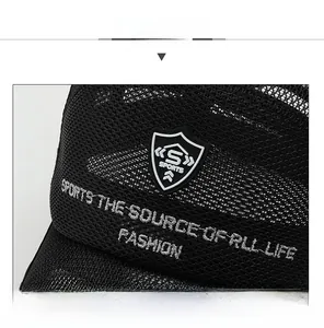 Detail of breathable honeycomb mesh on black sports cap with embroidered shield logo