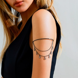 Detailed view of gothic black metal upper arm cuff with crystal chains and tassels