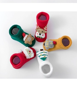 Detailed top view of five pairs of plush cotton Christmas socks with festive 3D characters