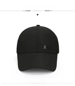 Detail of black mesh baseball cap showing embroidery with R and VOGUE on front