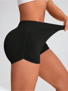 Close-up of high-stretch black seamless yoga shorts featuring side ruching and scrunch butt