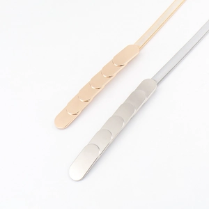 Detail of gold and silver elastic metal belts with flat oval links and interlocking buckle