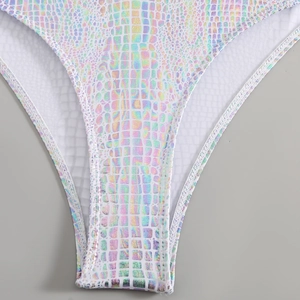 Macro shot of holographic crocodile pattern fabric and stitching on bikini bottom
