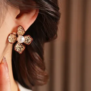 Elegant vintage red floral earrings with golden lace metal design and pearl center