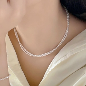 Close-up of double-layer natural freshwater pearl necklace with 14K gold plated clasp
