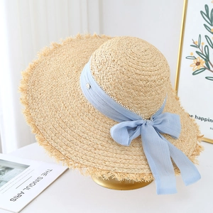 French woven raffia sun hat with long fringe brim and blue chiffon bow for beach vacation