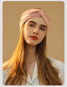 Close-up of pink twisted headband for women, soft maternity hair accessory on model