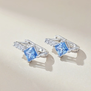 Macro shot of S925 sterling silver earring with square-cut blue zircon stones