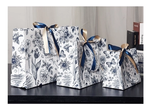 Three sizes of blue floral gift bags with elegant double silk ribbons and Happy Time text