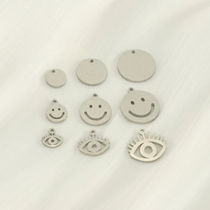 Polished stainless steel pendants in smiley and evil eye designs for DIY jewelry