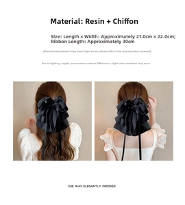Detail of black chiffon bow hair claw clip showing 30cm ribbon and resin texture