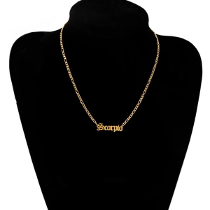 Detail of golden Scorpio zodiac necklace displayed on a premium black velvet jewelry bust