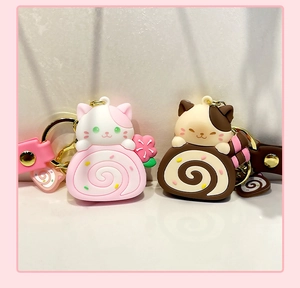 Detail of pink and brown silicone cat cake roll keychains with matching straps