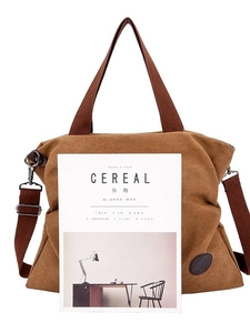 Grand sac cabas en toile avec poignées marron et bandoulière à côté du magazine Cereal