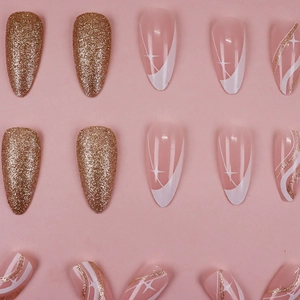 Almond shaped press-on nails with pink base, gold glitter, and French wave patterns