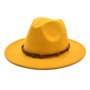 Detail of yellow wool fedora hat with brown leather band and punk skull buckle decor
