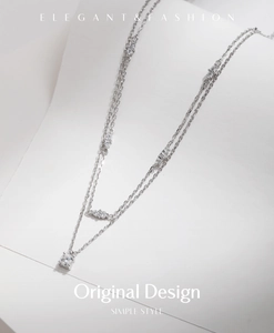 Detail of silver double-layer necklace with micro-set zircons and elegant chain texture