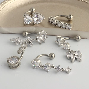 Set of five stainless steel belly button rings with sparkling cubic zirconia designs